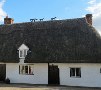 thatched Suffolk cottage with fox roof decoration